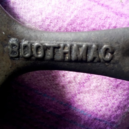 The skillet has the name Boothmac on the handle.  This foundry made grenade housing used i for World War 2. 